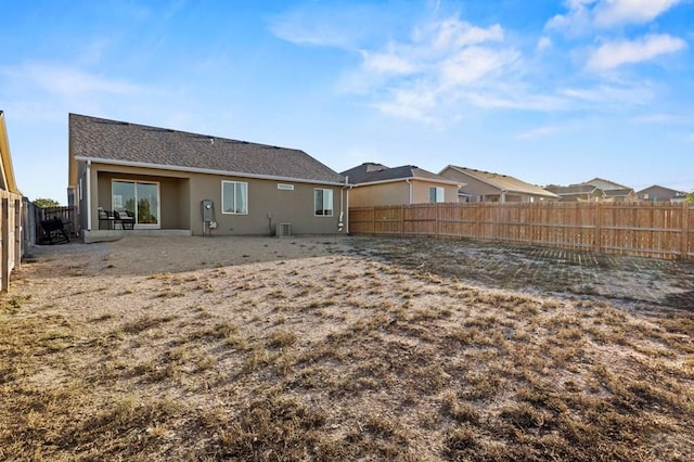 back of property featuring a patio area, a fenced backyard, central AC unit, and stucco siding