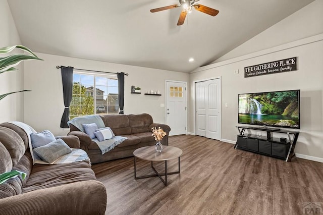 living room featuring lofted ceiling, a ceiling fan, baseboards, and wood finished floors