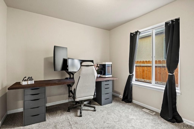 office space featuring visible vents, light carpet, and baseboards