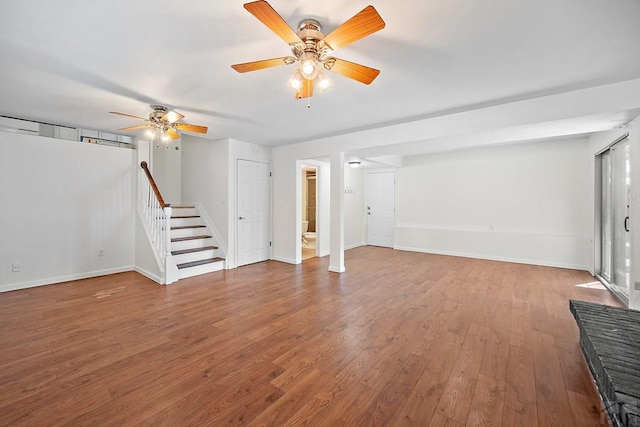 130 Montcalm Dr, Pueblo, CO 81005 - unfurnished living room featuring ceiling fan, wood finished floors, and stairway