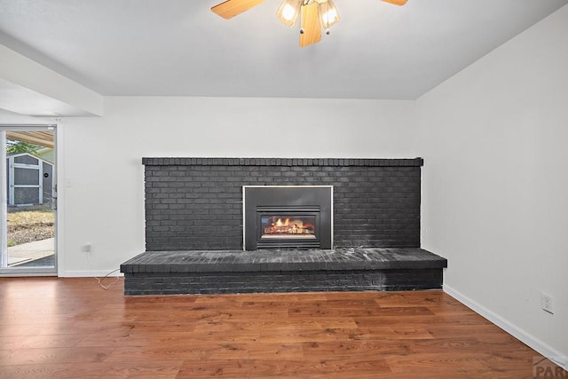130 Montcalm Dr, Pueblo, CO 81005 - detailed view of a brick fireplace, ceiling fan, and wood finished floors