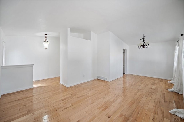 130 Montcalm Dr, Pueblo, CO 81005 - empty room with a chandelier, light wood-type flooring, and lofted ceiling