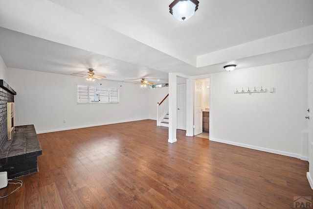 130 Montcalm Dr, Pueblo, CO 81005 - unfurnished living room featuring stairway, wood finished floors, ceiling fan, and a fireplace