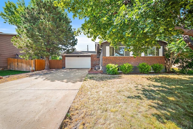 130 Montcalm Dr, Pueblo, CO 81005 - view of front facade with brick siding and a detached garage