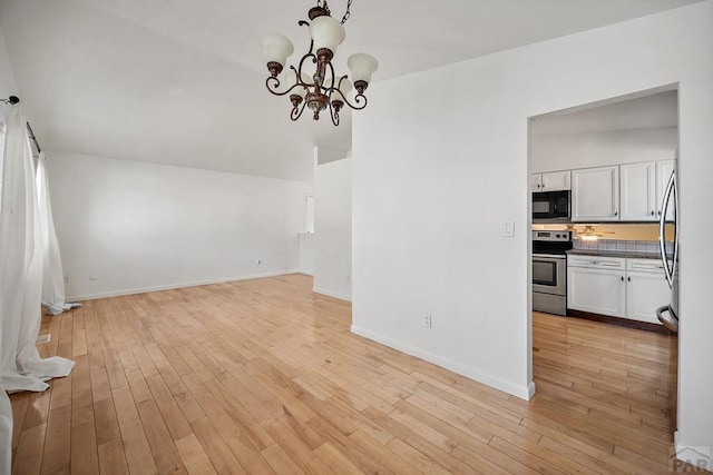 130 Montcalm Dr, Pueblo, CO 81005 - unfurnished dining area featuring a chandelier and light wood-style floors