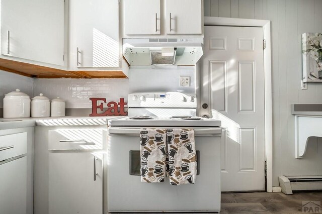 kitchen with under cabinet range hood, white cabinetry, light countertops, and electric stove