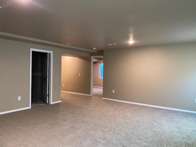 carpeted spare room with baseboards