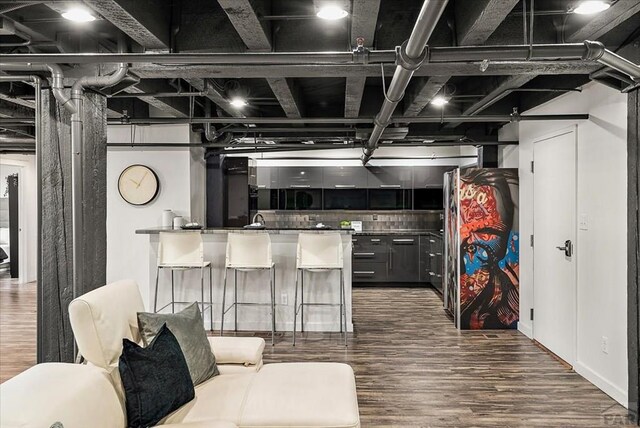 kitchen with tasteful backsplash, wood finished floors, and gray cabinetry