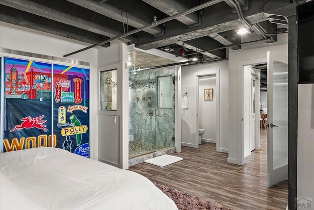 bedroom with baseboards and wood finished floors