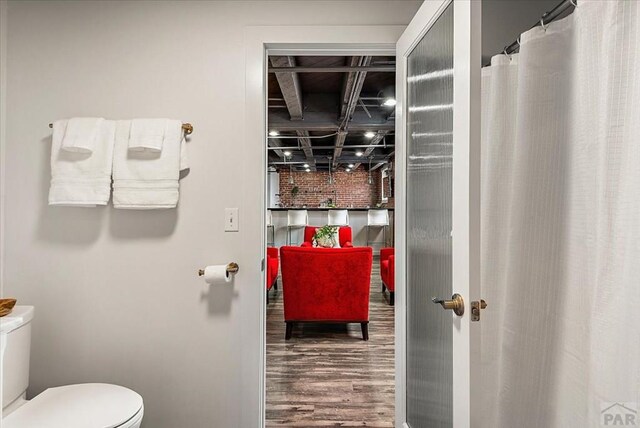 full bathroom with toilet and wood finished floors