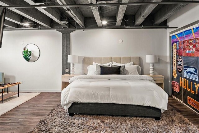 bedroom featuring baseboards and wood finished floors