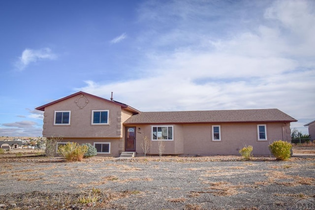 tri-level home featuring stucco siding