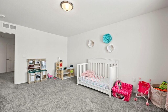 bedroom with visible vents and carpet flooring