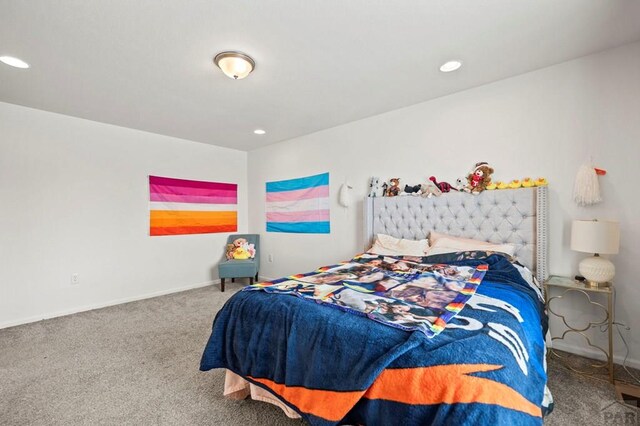 carpeted bedroom featuring baseboards and recessed lighting