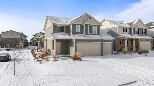 view of front of property featuring a garage, board and batten siding, and a residential view