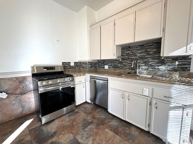 2023 N Elizabeth St, Pueblo, CO 81003 - kitchen featuring appliances with stainless steel finishes, stone finish flooring, dark stone countertops, and white cabinetry