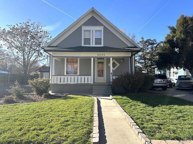 bungalow-style home featuring a porch and a front yard