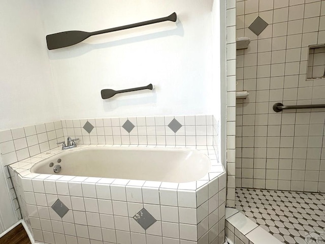 full bath featuring a garden tub and a tile shower