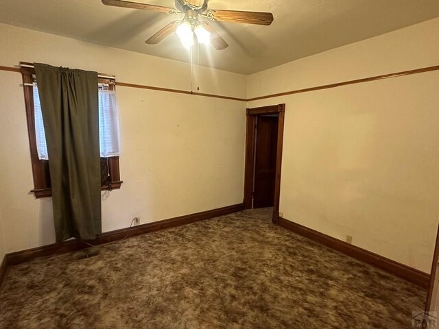 unfurnished room featuring carpet, ceiling fan, and baseboards