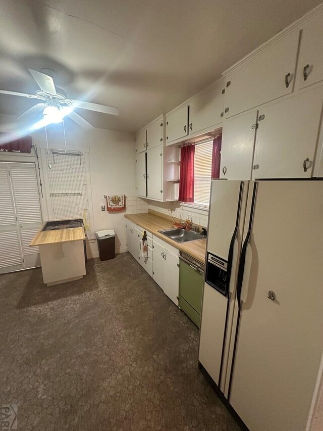 kitchen featuring white refrigerator with ice dispenser, light countertops, white cabinetry, open shelves, and stainless steel dishwasher