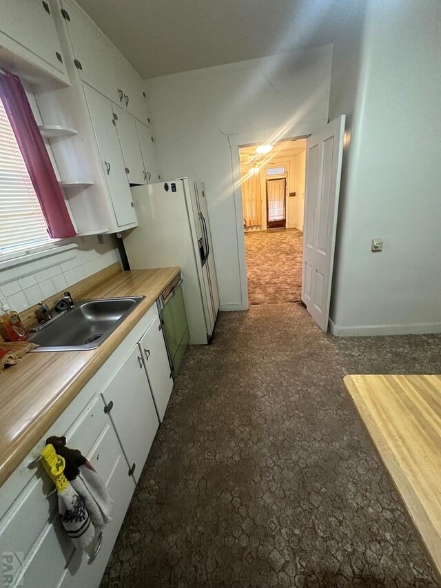 kitchen with open shelves, light countertops, decorative backsplash, white cabinetry, and a sink