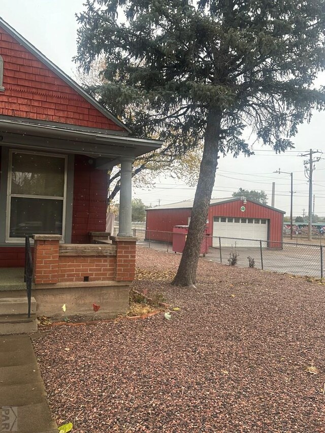 exterior space with an outbuilding and fence