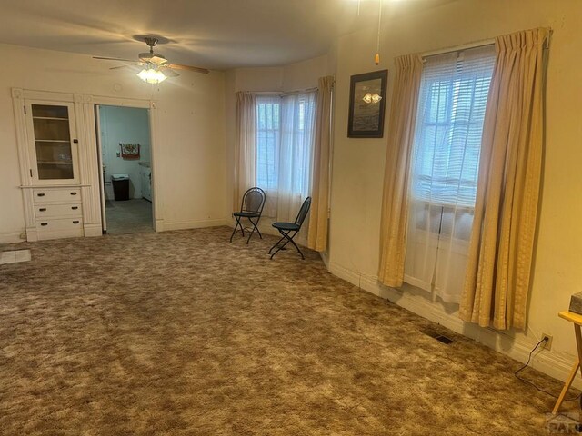 unfurnished room featuring ceiling fan, carpet flooring, and visible vents