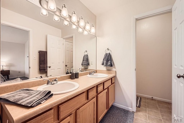 3603 Bobcat Ln, Pueblo, CO 81005 - full bath featuring double vanity, baseboards, and tile patterned flooring