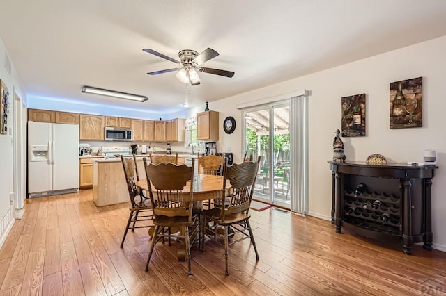 3603 Bobcat Ln, Pueblo, CO 81005 - dining space featuring light wood-style floors, ceiling fan, a dry bar, and baseboards