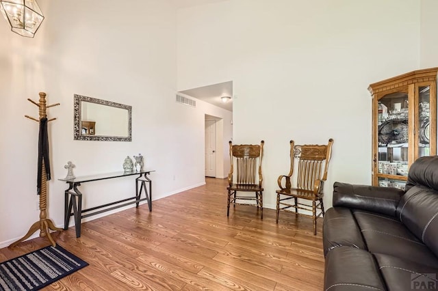 3603 Bobcat Ln, Pueblo, CO 81005 - living room featuring a high ceiling, wood finished floors, and baseboards