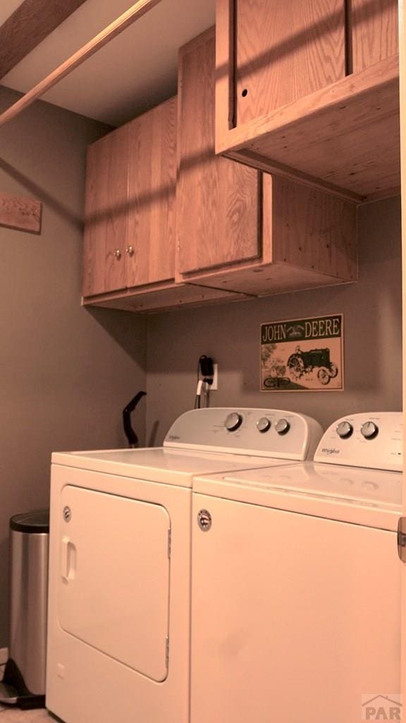 laundry area with washer and dryer and cabinet space