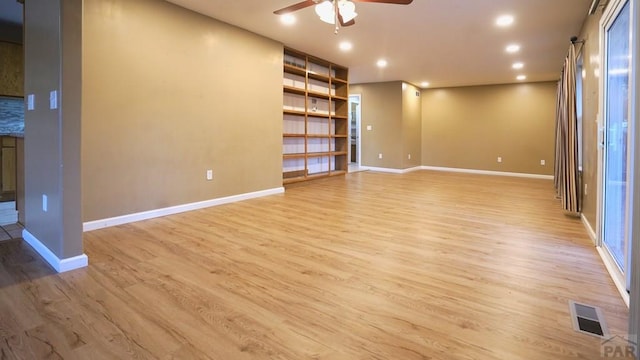 spare room with recessed lighting, visible vents, ceiling fan, light wood-type flooring, and baseboards