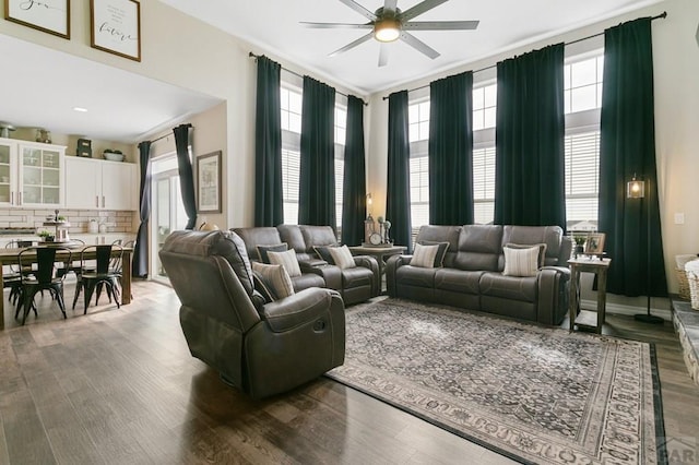 living room featuring wood finished floors and a ceiling fan