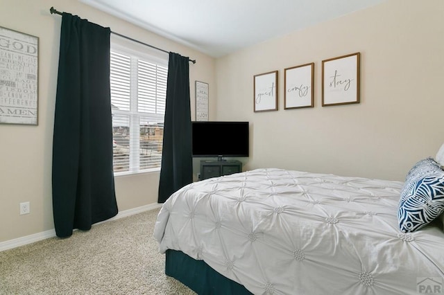carpeted bedroom featuring baseboards