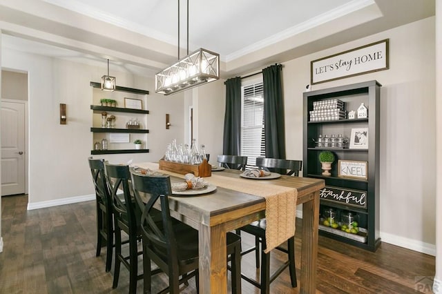 dining area featuring ornamental molding, baseboards, a notable chandelier, and dark wood finished floors