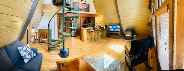 living room with wood walls and wood finished floors