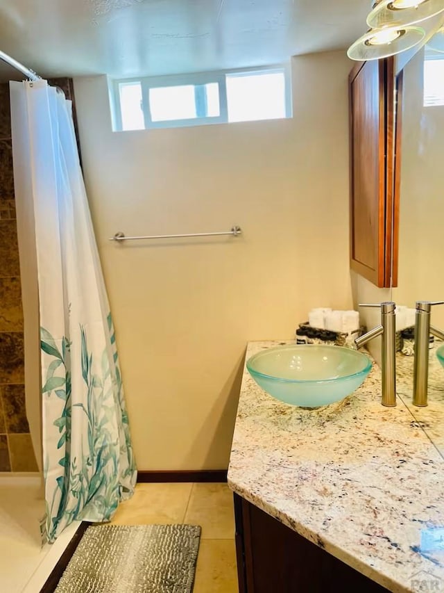 bathroom featuring a stall shower, tile patterned flooring, and vanity