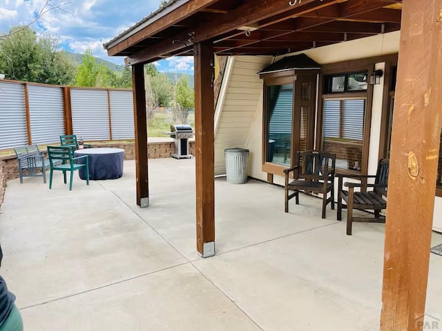 view of patio with an outdoor fire pit and area for grilling