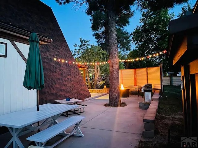 view of patio with outdoor dining space, an outdoor fire pit, and area for grilling