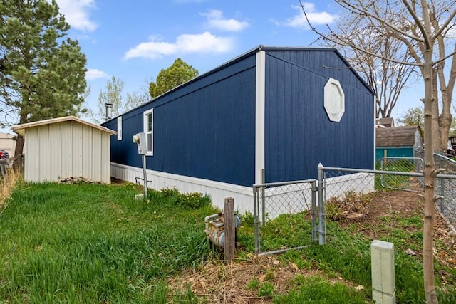 400 Hickory St Unit 172, Fort Collins, CO 80524 - view of side of home featuring an outbuilding, a storage shed, and fence