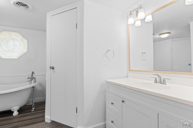 400 Hickory St Unit 172, Fort Collins, CO 80524 - full bathroom featuring baseboards, visible vents, a soaking tub, vanity, and wood finished floors