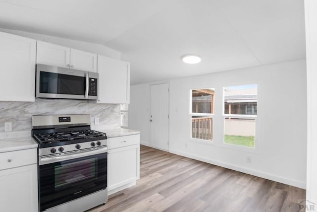 400 Hickory St Unit 172, Fort Collins, CO 80524 - kitchen with white cabinetry, light wood-style floors, stainless steel appliances, and baseboards