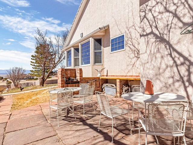 view of patio / terrace featuring exterior bar and outdoor dining space