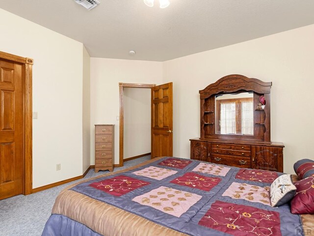 bedroom featuring light carpet, visible vents, and baseboards