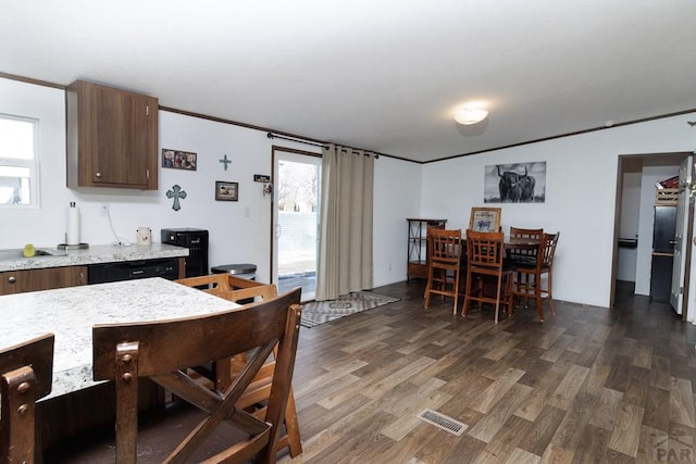 kitchen with dark wood-style floors, light countertops, visible vents, and a healthy amount of sunlight