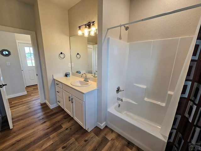 28781 County Rd 24.6, Springfield, CO 81073 - full bathroom with wood finished floors, shower / bath combination, vanity, and baseboards