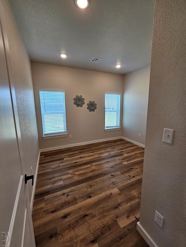 28781 County Rd 24.6, Springfield, CO 81073 - empty room featuring dark wood-style floors, plenty of natural light, a textured ceiling, recessed lighting, and baseboards