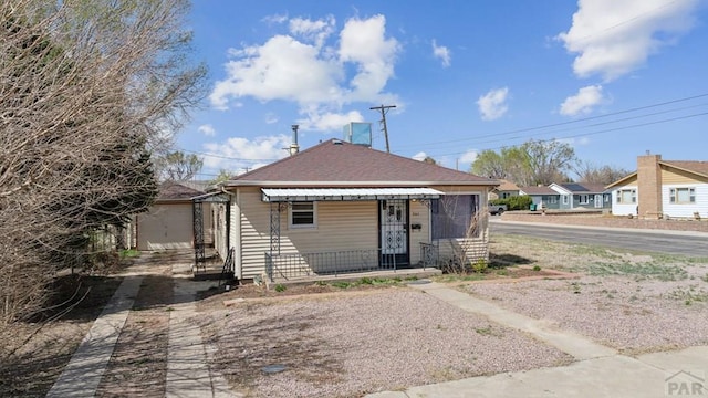 view of front of house featuring roof with shingles