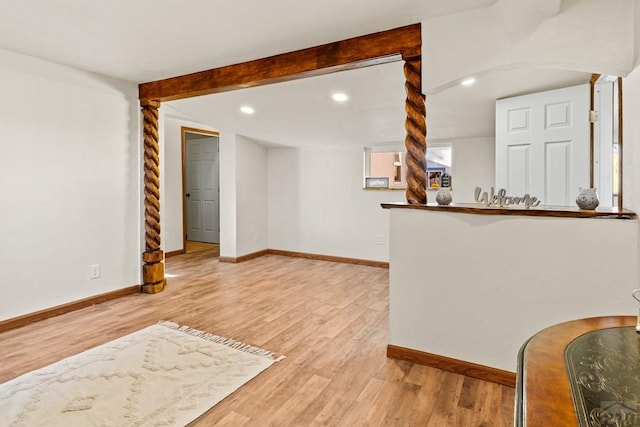 interior space with arched walkways, recessed lighting, wood finished floors, beamed ceiling, and baseboards