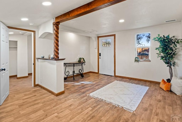 foyer entrance featuring light wood-style floors, baseboards, and visible vents